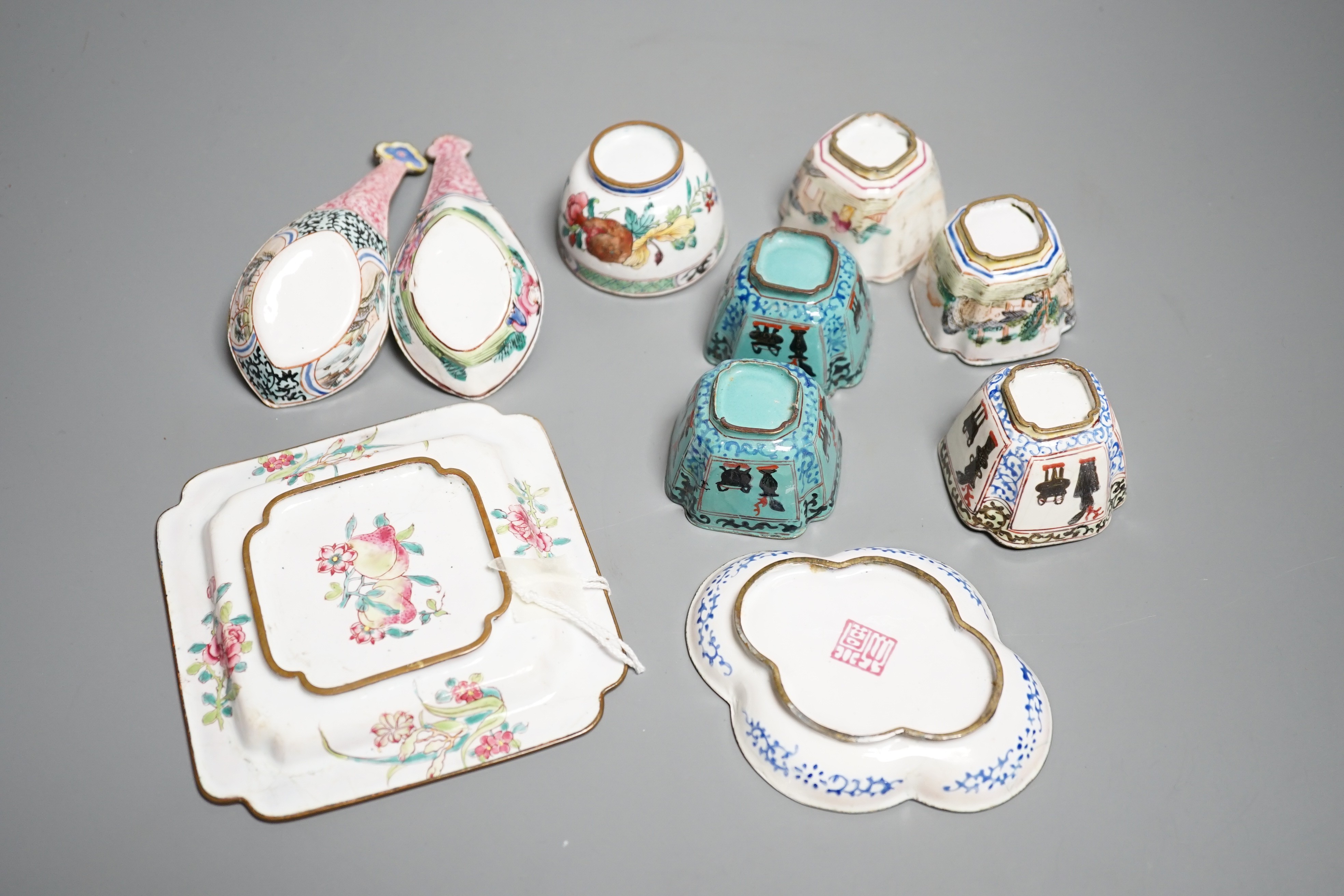 Nine pieces of Chinese Canton enamel wares, Qianlong period, including two enamel dishes, two rice spoons, and six various cups, largest 11cm